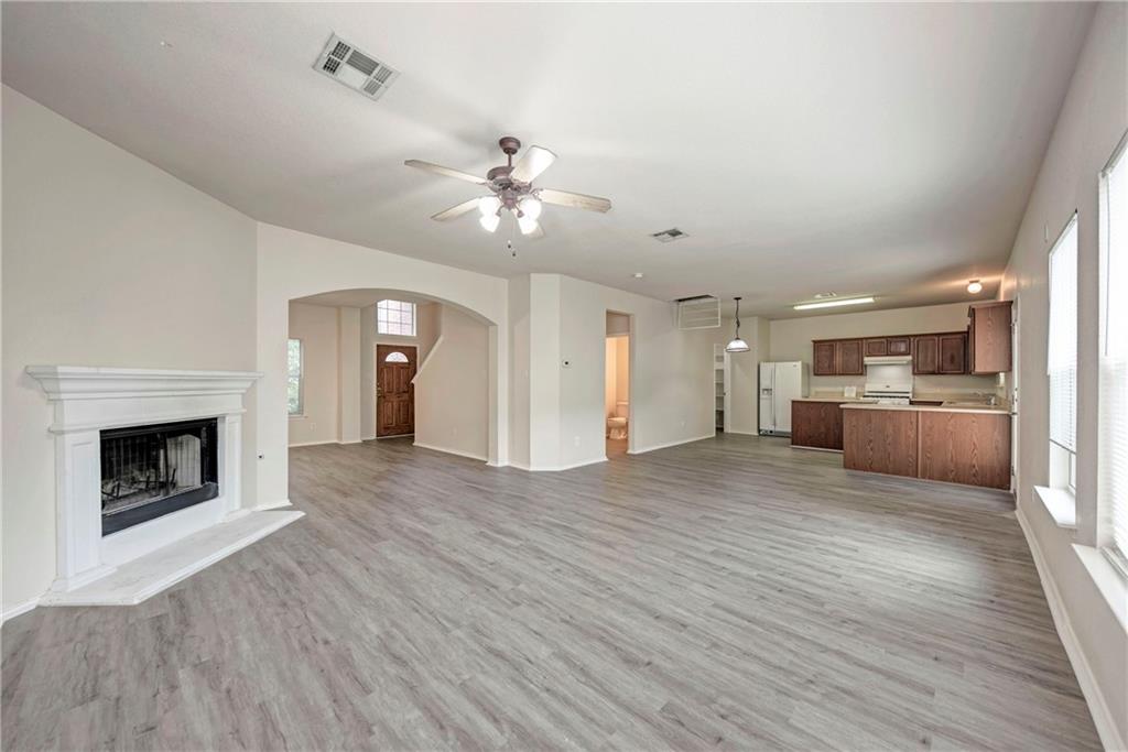 1962 Rachel Lane Round Rock, TX 78664 - Photo 3 of 22 a view of a kitchen with furniture a ceiling fan and wooden floor