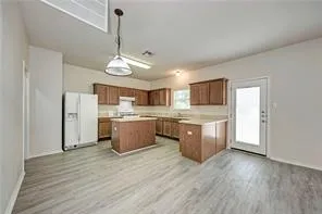 a kitchen with stainless steel appliances granite countertop a sink cabinets and wooden floor
