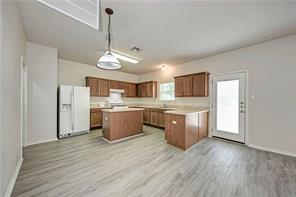 1962 Rachel Lane Round Rock, TX 78664 - Photo 7 of 22 a kitchen with stainless steel appliances granite countertop a sink cabinets and wooden floor