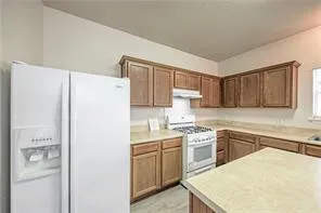 a kitchen with a white cabinets and white appliances