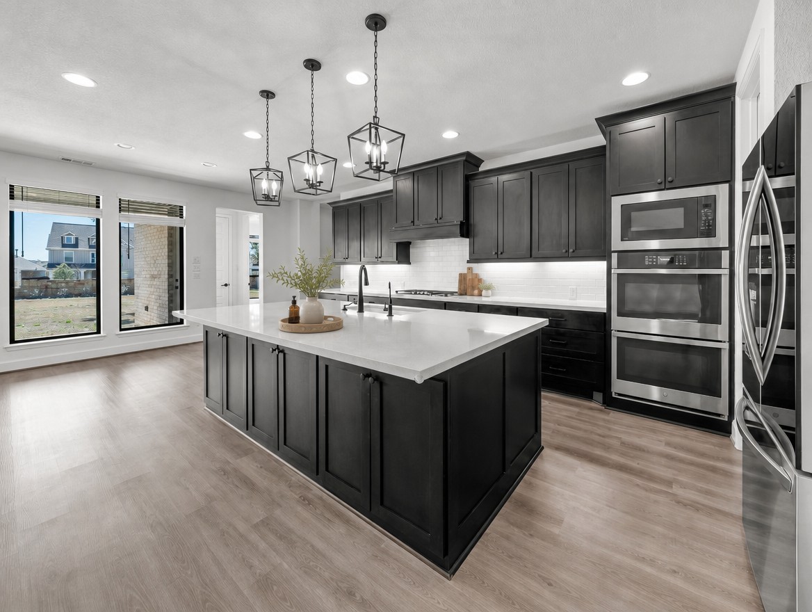 1440 Riva Ridge Drive Leander, TX 78641 - Photo 11 of 37 A well-appointed kitchen showcasing a spacious island with ample counter space and modern black cabinetry.