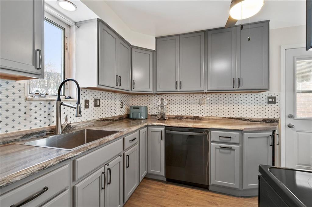 6617 Landview Road Pittsburgh, PA 15217 - Photo 7 of 23 a kitchen with a sink cabinets and stainless steel appliances