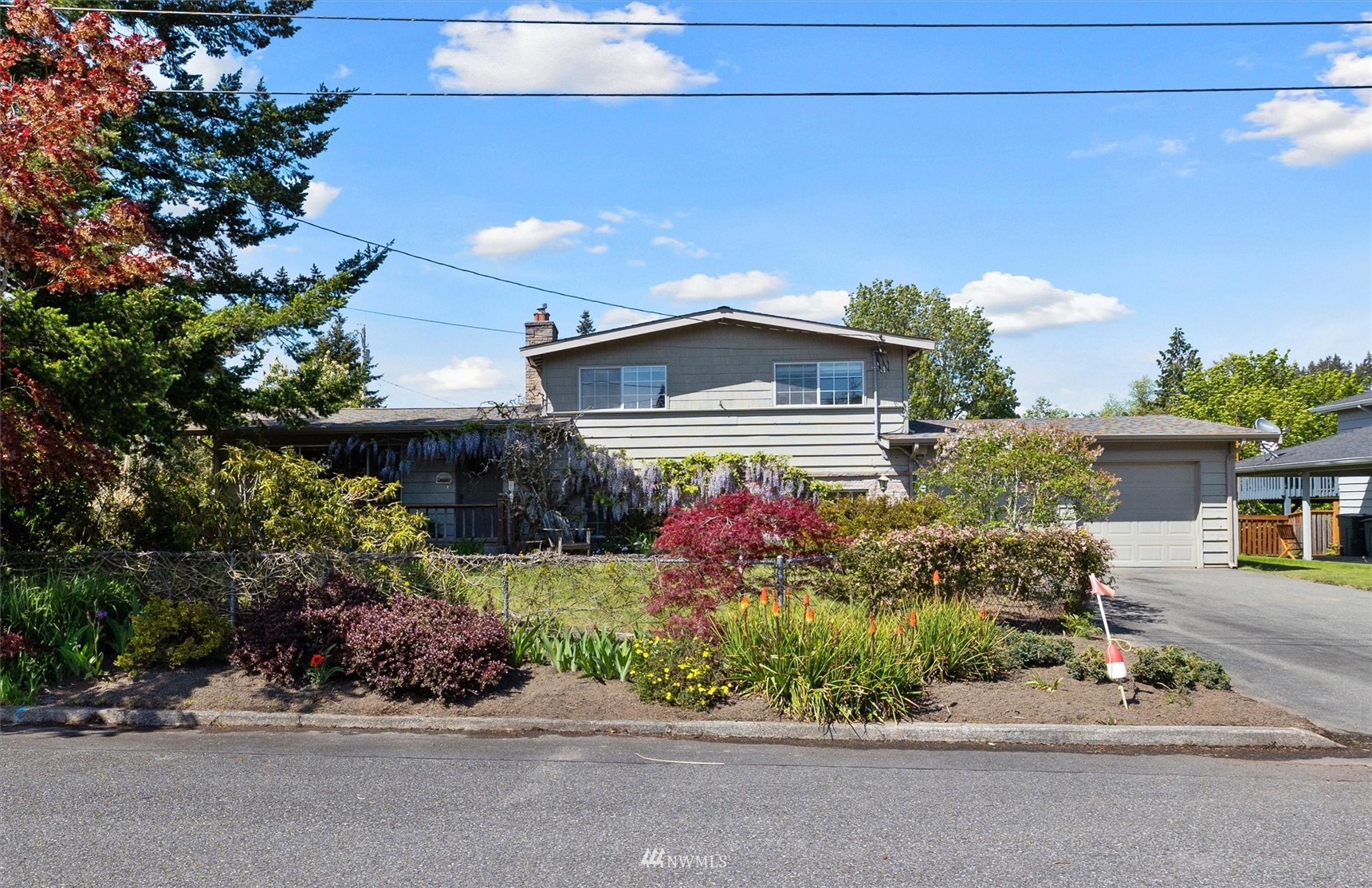 1005 Cascade Drive Edmonds, WA 98020 - Photo 3 of 22 a front view of a house with a yard and a garage