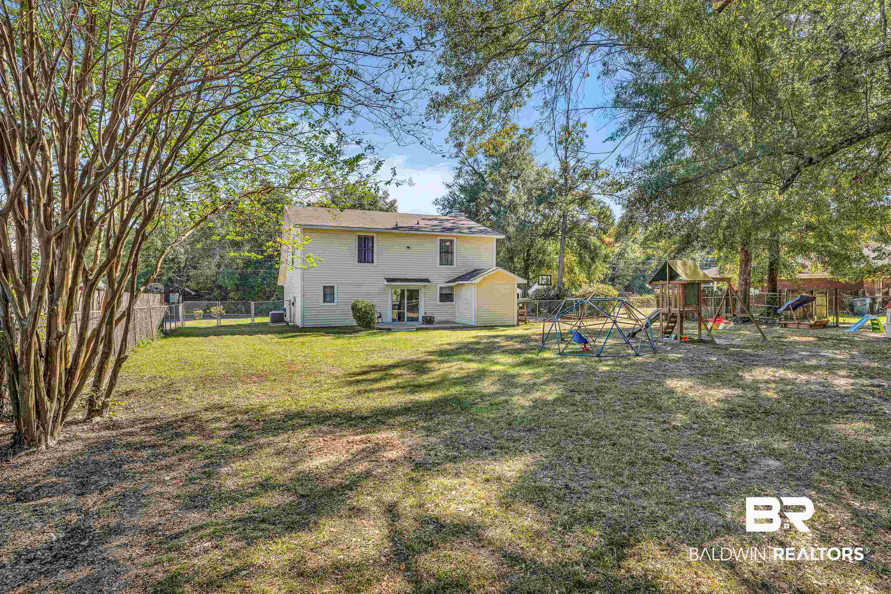 6135 Oak Cliff Drive Eight Mile, AL 36613 - Photo 29 of 30 Back of house with a playground and a fenced backyard