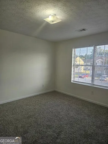 an empty room with a empty space and windows