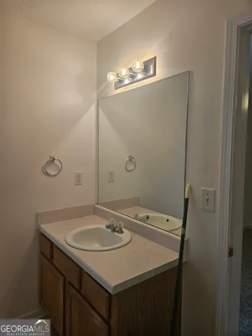 a bathroom with a sink a vanity and a mirror