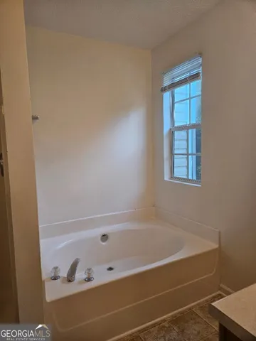a bath tub sitting next to a window