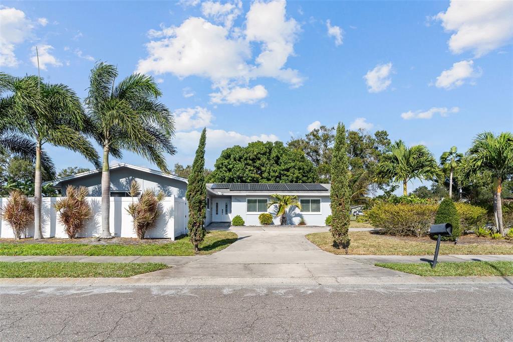 a view of a house with a yard and a garage