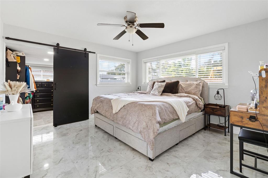 2453 Roberta Street Largo, FL 33771 - Photo 14 of 29 a spacious bedroom with a bed and dresser