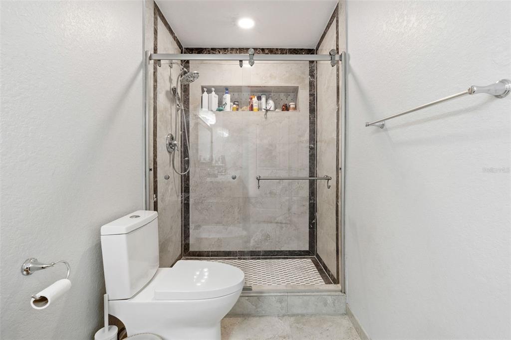 2453 Roberta Street Largo, FL 33771 - Photo 17 of 29 a bathroom with a shower and a toilet