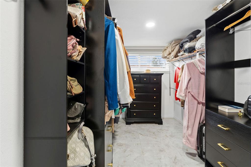2453 Roberta Street Largo, FL 33771 - Photo 18 of 29 a view of walk in closet with clothes and shoes