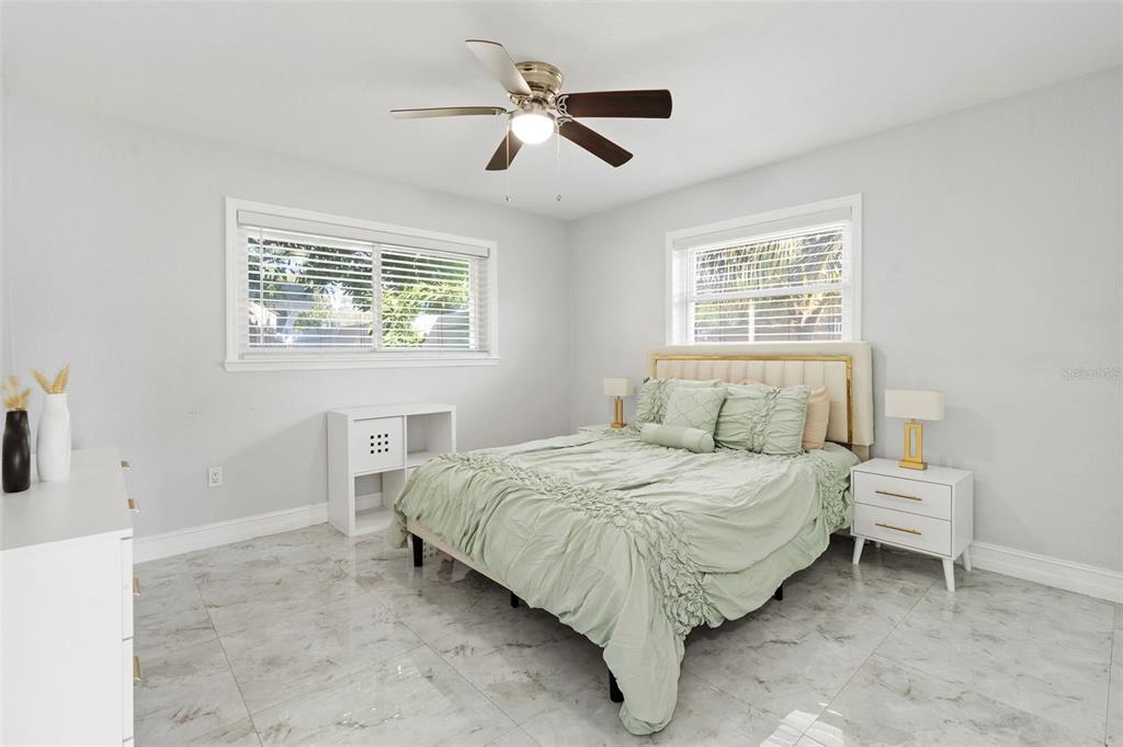 2453 Roberta Street Largo, FL 33771 - Photo 21 of 29 a bedroom with a bed and a ceiling fan