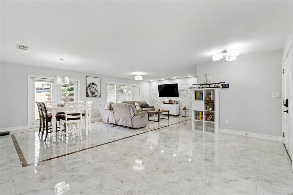 2453 Roberta Street Largo, FL 33771 - Photo 3 of 29 a living room with furniture and a flat screen tv