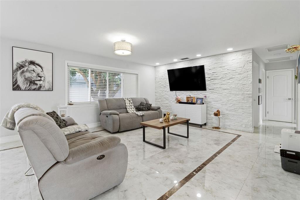 2453 Roberta Street Largo, FL 33771 - Photo 4 of 29 a living room with furniture and a flat screen tv