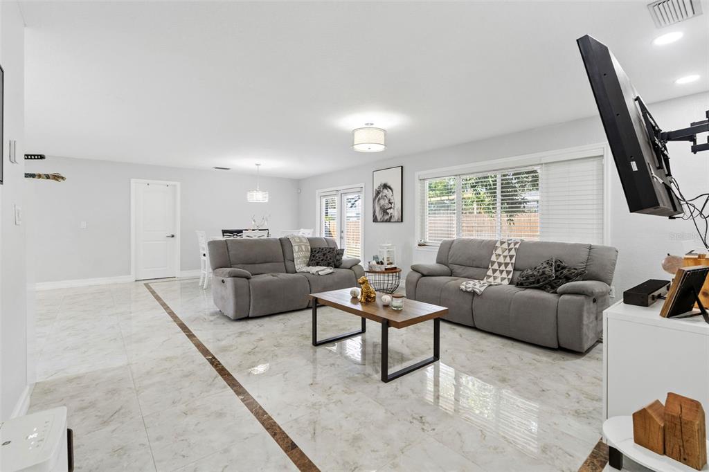 2453 Roberta Street Largo, FL 33771 - Photo 5 of 29 a living room with furniture and a flat screen tv