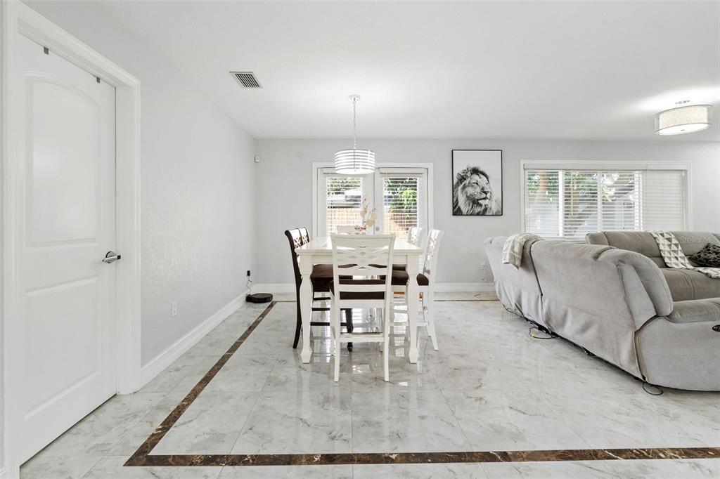 2453 Roberta Street Largo, FL 33771 - Photo 6 of 29 a living room with furniture a dining table and a window