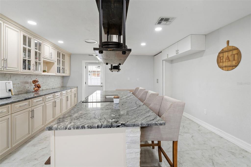 2453 Roberta Street Largo, FL 33771 - Photo 9 of 29 a kitchen with a table and chairs in it