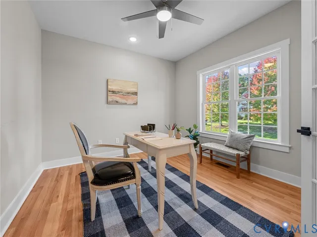 a view of a workspace with furniture and a window