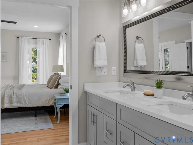 a spacious bathroom with a sink a large mirror and a shower