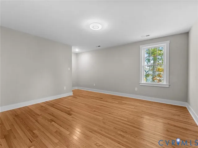 a view of an empty room and wooden floor
