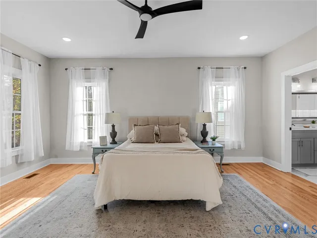 a spacious bedroom with a bed a window and closet