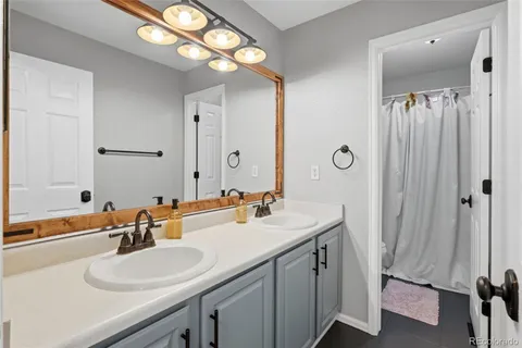 a bathroom with a double vanity sink and a mirror