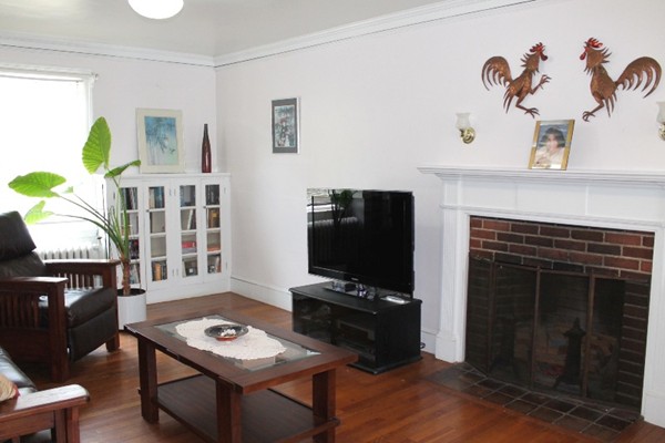2 Raymond Street Lexington, MA 02421 - Photo 4 of 18 a living room with furniture a flat screen tv and a fireplace