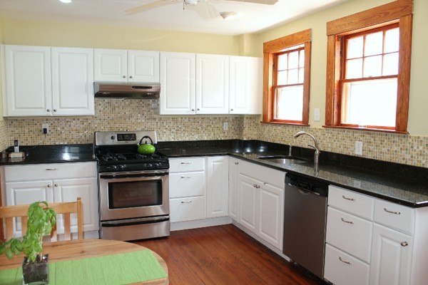 2 Raymond Street Lexington, MA 02421 - Photo 8 of 18 a kitchen with granite countertop a sink stainless steel appliances and cabinets