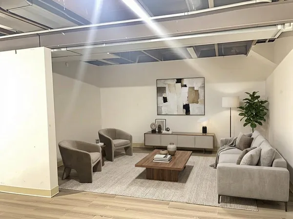a living room with furniture and a wooden floor