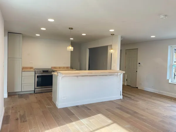 a view of kitchen with granite countertop cabinets and wooden floor