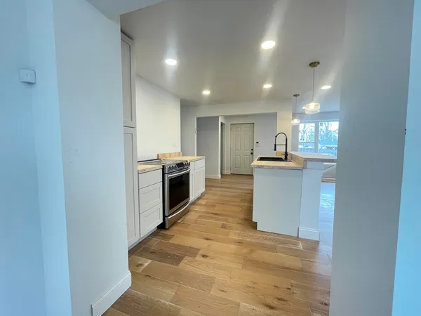 a kitchen with stainless steel appliances granite countertop a sink and a stove top oven