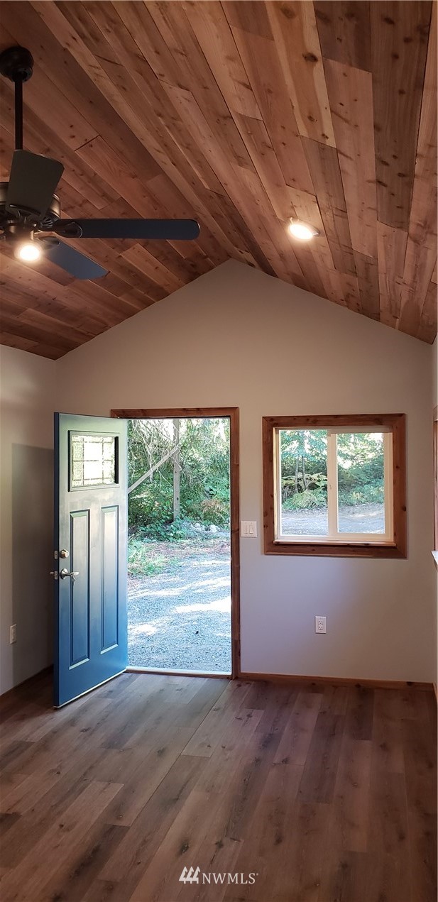 17613 Rouse Road Southwest Longbranch, WA 98351 - Photo 11 of 38 an empty room with wooden floor and windows