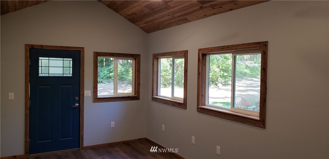 17613 Rouse Road Southwest Longbranch, WA 98351 - Photo 14 of 38 an empty room with wooden floor and windows