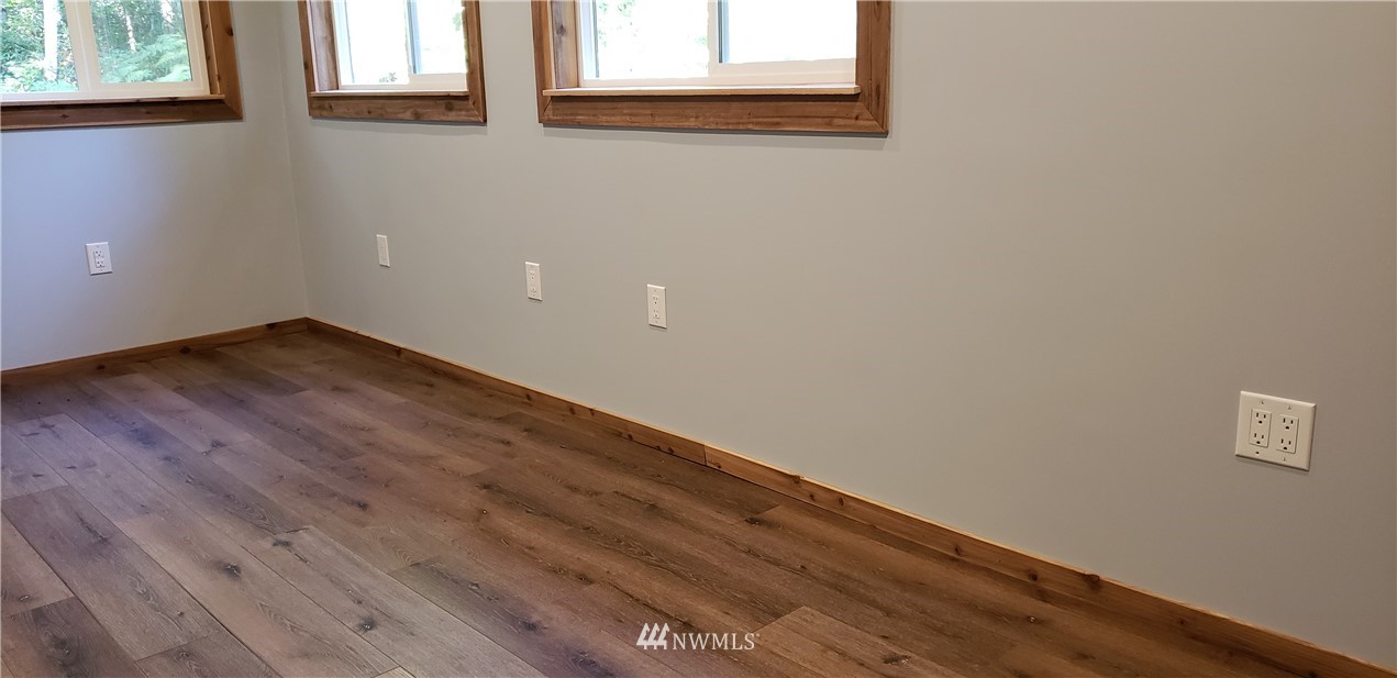 17613 Rouse Road Southwest Longbranch, WA 98351 - Photo 15 of 38 a view of empty room with wooden floor and fan
