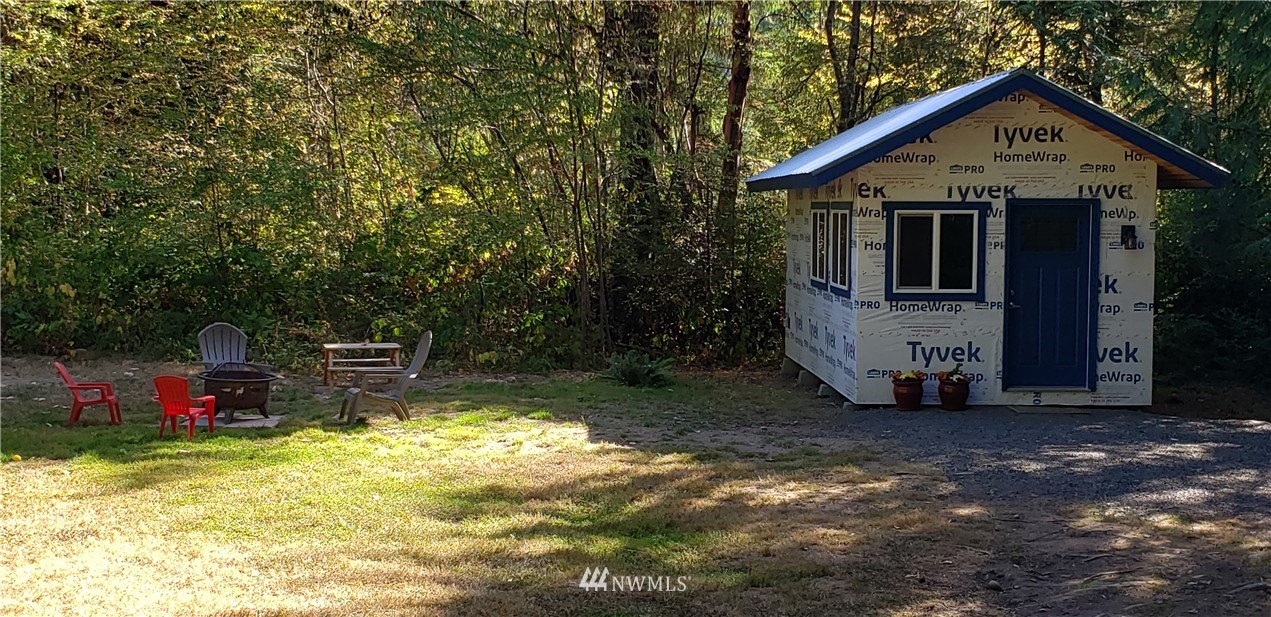 17613 Rouse Road Southwest Longbranch, WA 98351 - Photo 6 of 38 a view of a small house with wooden fence