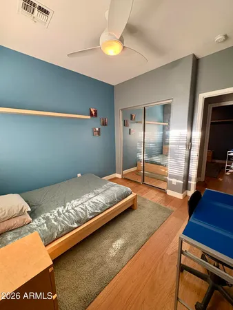 a bedroom with a bed and a flat screen tv