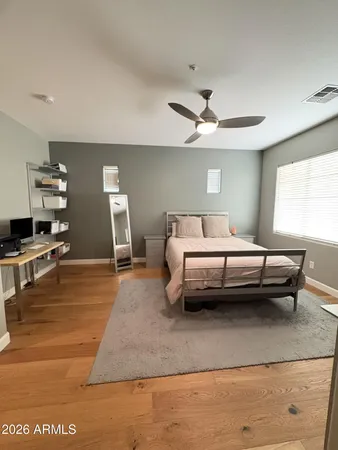 a bedroom with furniture and a ceiling fan