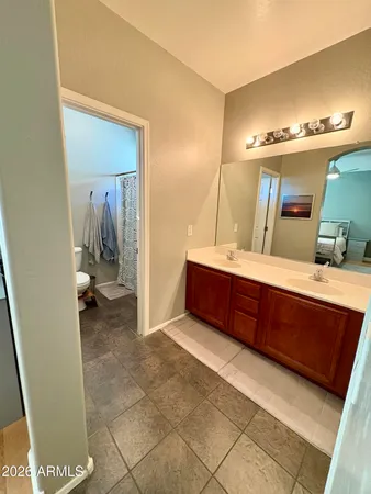 a bathroom with a double vanity sink and a mirror