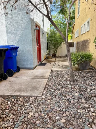 a pathway of a house with a yard