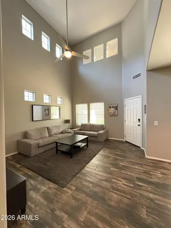 a living room with furniture and a chandelier