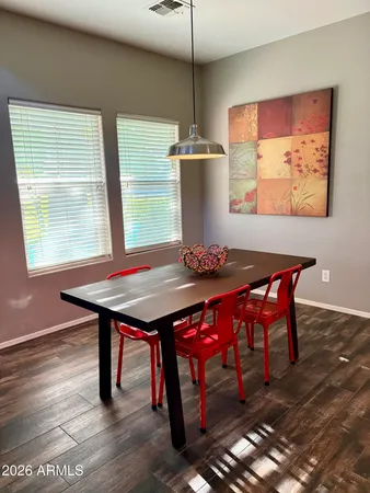 a dining room with a wooden table and chairs