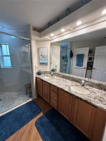 a spacious bathroom with a granite countertop sink and a mirror
