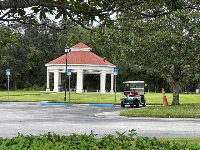 a car parked in front of a house and a yard in the background