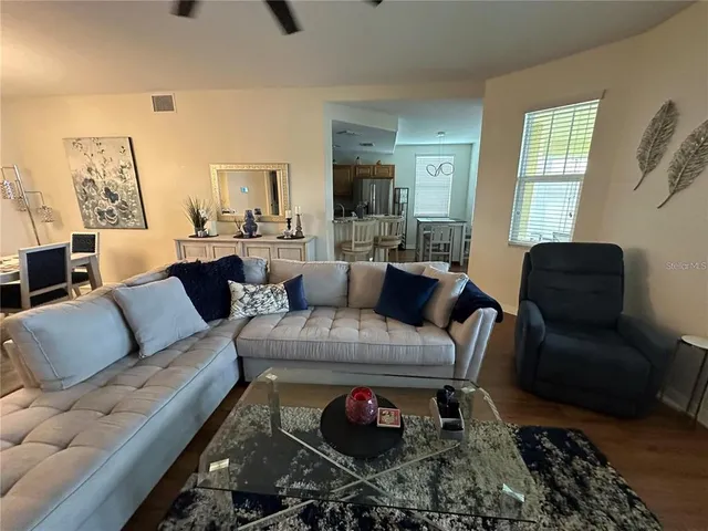 a living room with furniture or couch and a wooden floor