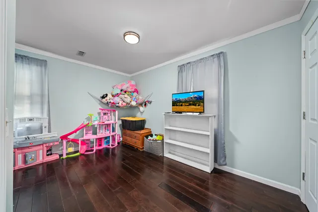 a bedroom with furniture and a wooden floor