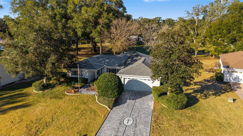 a view of a house with a yard and sitting area