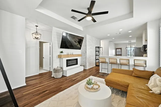 a living room with furniture a fireplace and a flat screen tv
