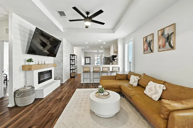 a living room with furniture a fireplace and flat screen tv