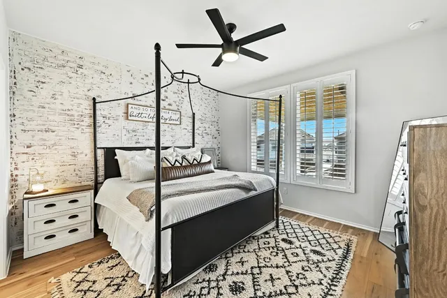 a bedroom with a bed a rug and a window