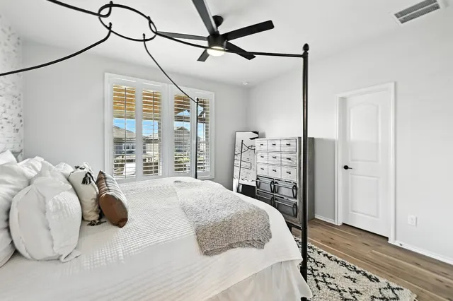 a bedroom with a bed and a chandelier